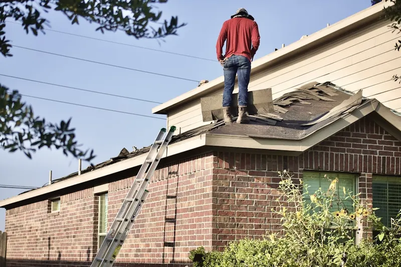 Professional roofer working on a residential roof in Nuevo
